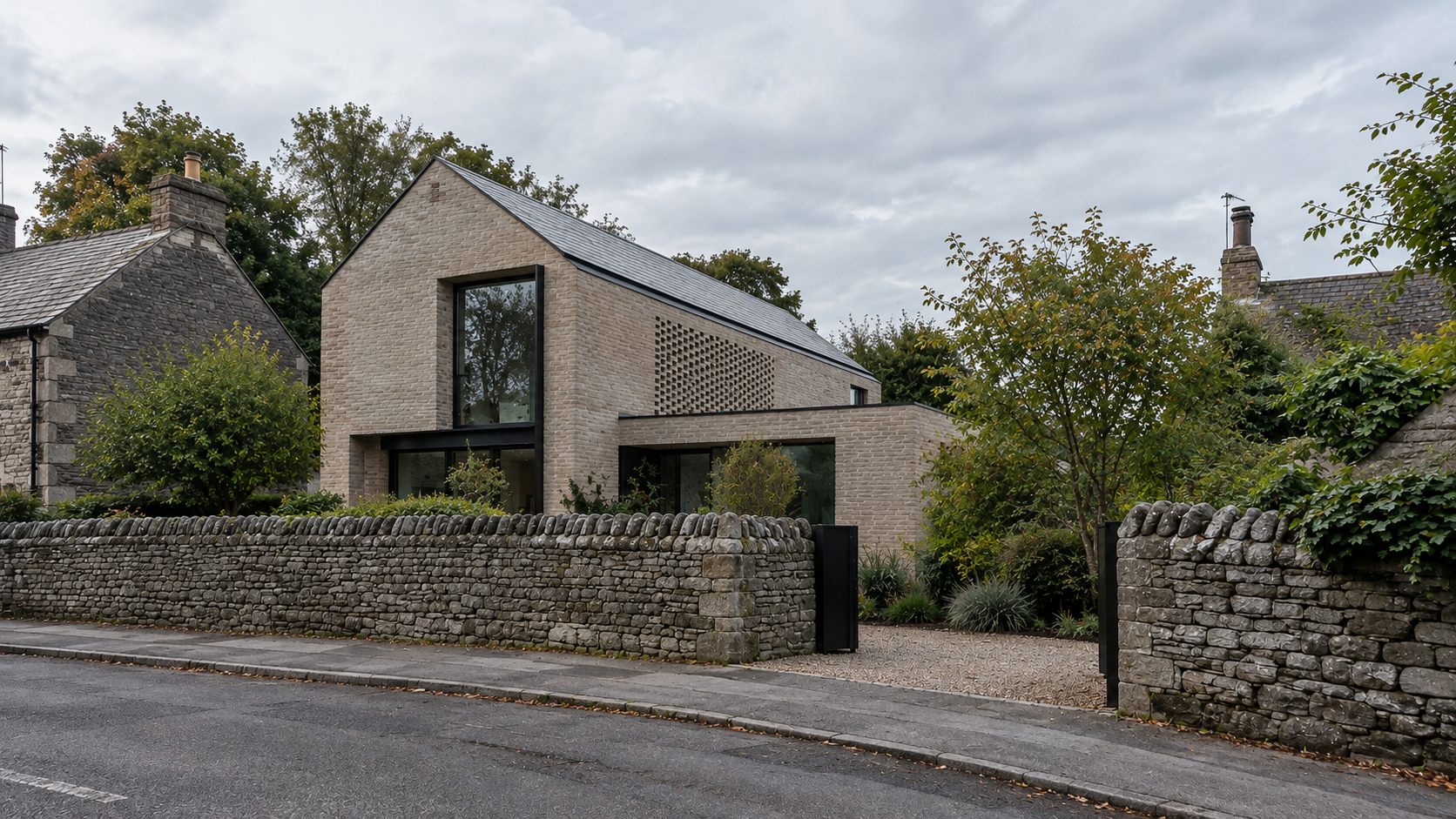 Village Home: a pale brick gabled house behind a dry-stone wall in an English village