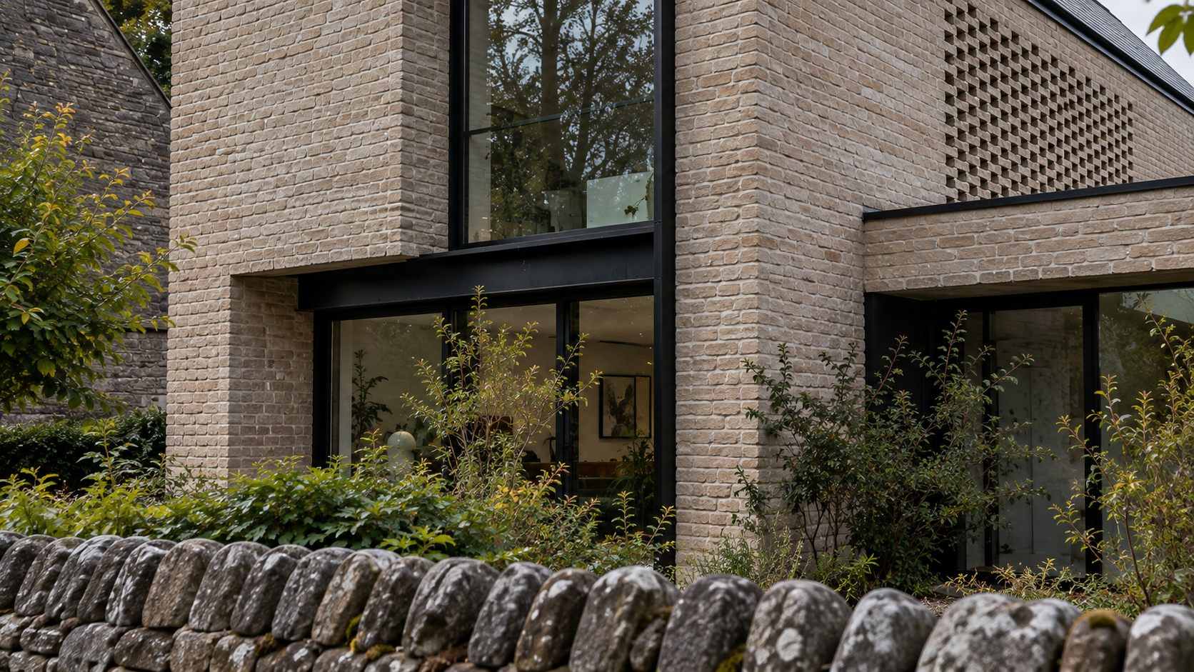 Village Home: a pale brick gabled house behind a dry-stone wall in an English village
